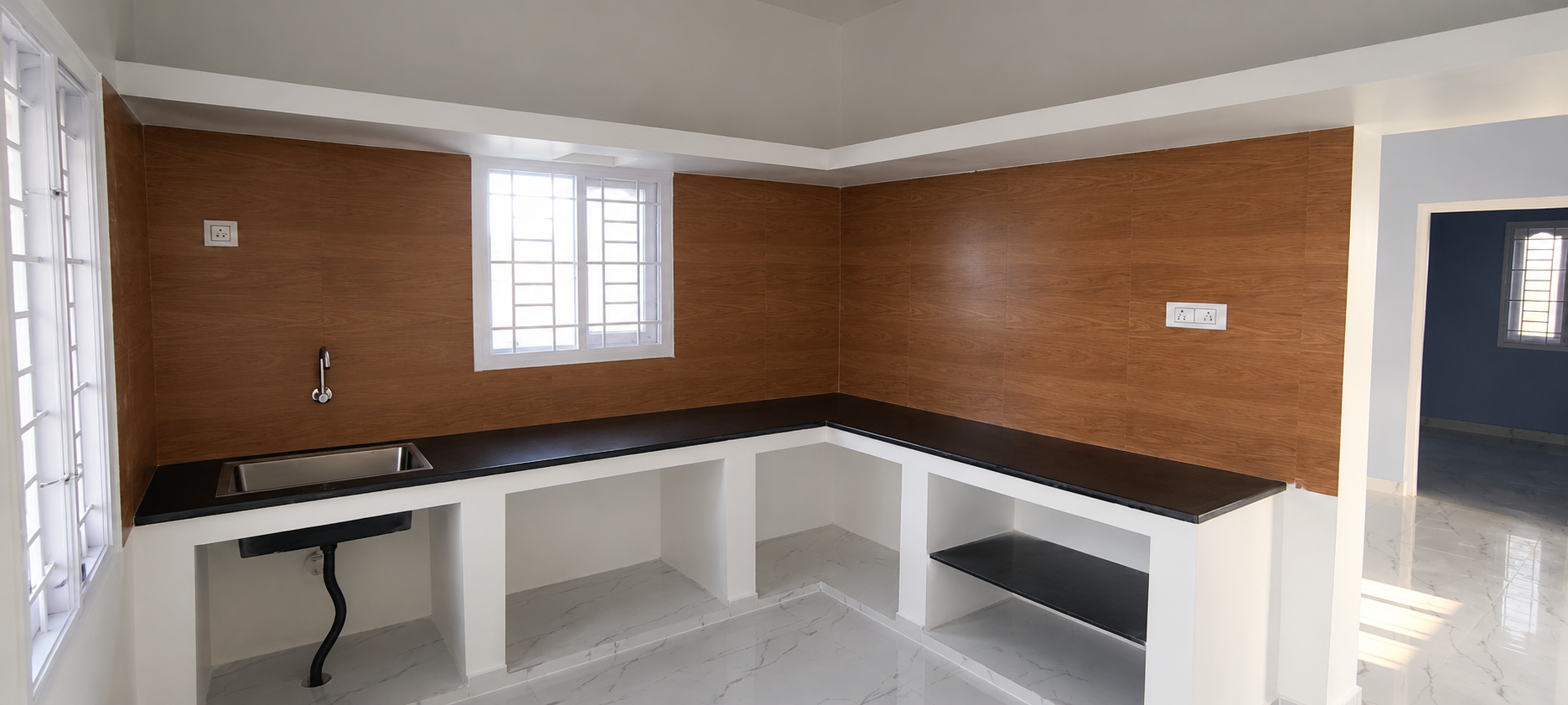 Modern kitchen with wood-look tile backsplash, granite countertops and open storage built by Sripad Builders